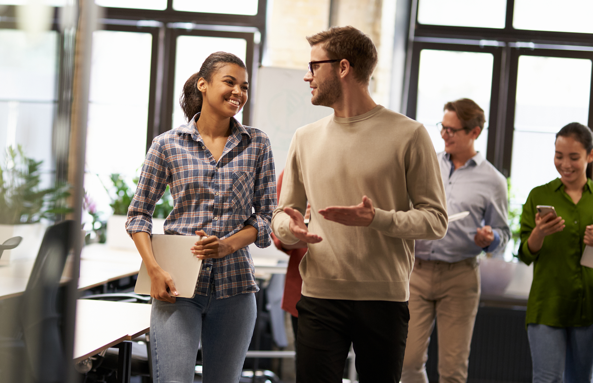 Colleagues working together laughing in relaxed environment 
