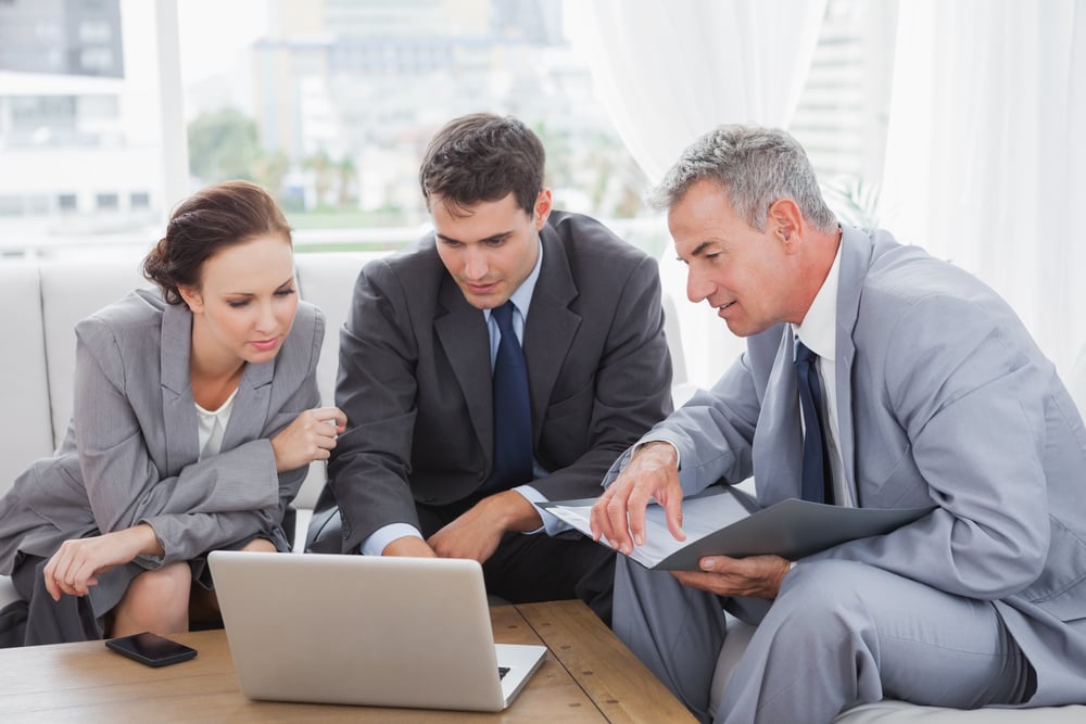 Business people working together on their laptop in meeting room