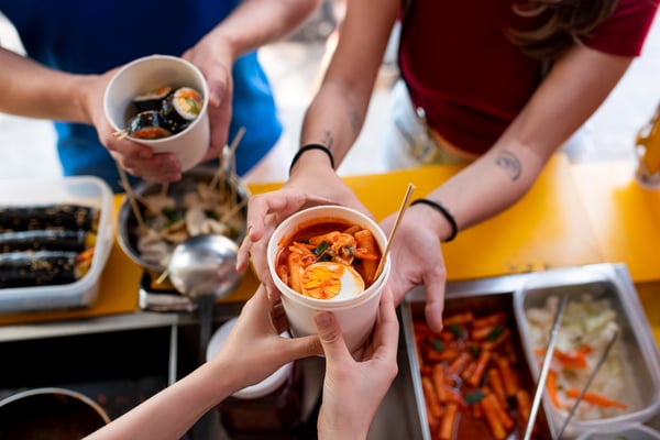 close-up-hands-holding-cup-with-food