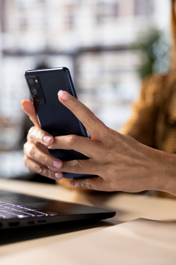 professional-woman-checking-her-smartphone-business-emails